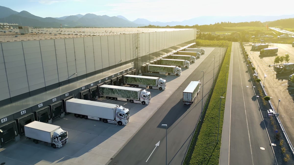 Aerial view of a distribution warehouse with trucks lined up at loading docks